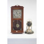 A Kundo 400-day mantel clock under domed glass dust shade, 11½” high; & a Spectrum quartz wall clock