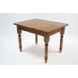 A pine kitchen table with rounded corners to the rectangular top, & turned tapered legs, 42" x 3½".