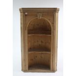 A pine hanging corner cabinet with rounded back & fitted two shaped shelves, 30" wide x 49" high.