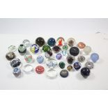 Approximately thirty various glass paperweights.