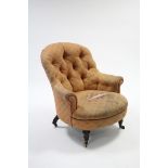 A Victorian buttoned back easy chair (requires re-upholstery), on walnut short turned legs with