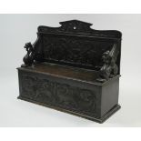 A VICTORIAN CARVED OAK BOX-SEAT SETTLE with Griffin supports, 52" long x 42" high.