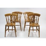 A set of four kitchen chairs with shaped & pierced splat backs, hard seats, & on turned legs with