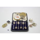 A set of six George V silver coffee spoons, Chester 1923, cased; together with two silver napkin