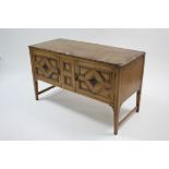 A pine low sideboard (with replacement top) enclosed by pair of panel doors, &on short square