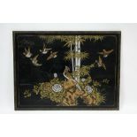 A Chinoiserie lacquer rectangular panel decorated with birds amongst flowering shrubs & bamboo,