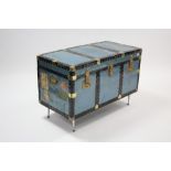 An early 20th century brass-bound & fibre-covered travelling trunk with hinged lift-lid & wrought-