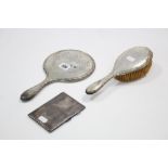 A George V silver-backed hand mirror & hair brush with engraved foliate & ribbon bow design,