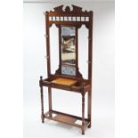 A Victorian mahogany hallstand inset rectangular bevelled mirror to top above a pair of tiles &