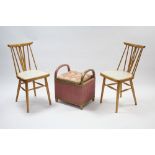A pair of spindle-back kitchen chairs with padded seats & on round tapered legs with spindle