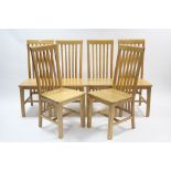 A set of six light oak rail-back dining chairs with hard seats & on square legs with plain