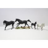 Two Royal Doulton horse ornaments; together with two other horse ornaments.