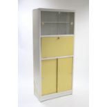 A mid-20th century white painted wooden tall kitchen cabinet, fitted shelf to top enclosed by pair
