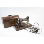 A Singer hand sewing machine, w.o., with walnut case; a19th century mahogany writing slope (