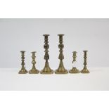 A pair of 11½” brass candlesticks with diamond pattern baluster columns; a matching pair of 6¾”