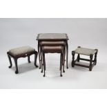 A reproduction mahogany nest of three rectangular occasional tables, each inset tooled leather cloth