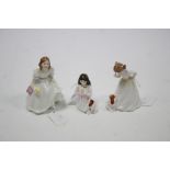 Three Royal Doulton bone china figures “Innocence” (HN 3730), “Lynsey” (HN 3043), & “Sit” (HN