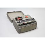 A Stellaphone portable reel-to-reel tape recorder in grey fibre-covered case.