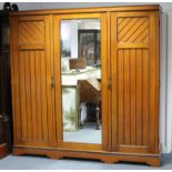 A VICTORIAN ASH TRIPLE-SECTION WARDROBE with fitted interior enclosed by rectangular mirror door