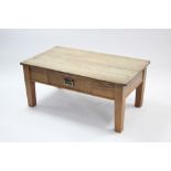 A pine rectangular low coffee table fitted centre frieze drawer & on short square tapered legs,