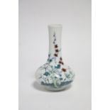 A Chinese porcelain small squat round vase with tall narrow neck, painted in Doucai enamels with