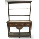 A REGENCY OAK SMALL DRESSER with open shelves above, the base fitted three frieze drawers above a