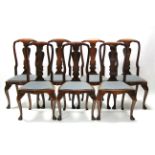 A set of ten George I style walnut dining chairs with shaped solid splats to the open backs,