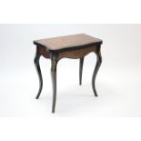 A 19th century Boulle inlaid & ebonised card table, the fold-over top of serpentine outline, on four