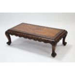 A Chinese elm low rectangular occasional table with carved borders & frieze, on short curved legs,