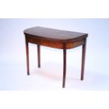 A George III figured mahogany card table with narrow rosewood crossbanding to the rectangular fold-