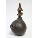 An African smoking pipe with short bowl to the round gourd body, with carved figural handle,