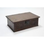 A late 17th century oak Bible box with original hinges to the lift top, & with carved front; 23"