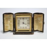 A 1930's travelling timepiece with eight-day alarm movement, in gilt engine-turned square case,