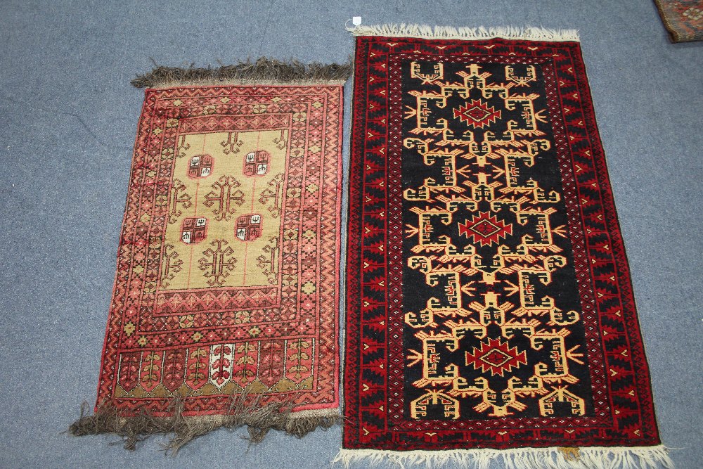 A Persian rug of dark blue ground, with cream hook pattern within crimson border, 60" x 35"; & a