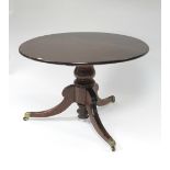 A Regency mahogany breakfast table, the circular figured tilt-top on turned baluster centre column &
