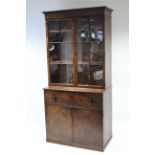 An early 19th century mahogany secretaire bookcase enclosed pair of glazed doors above, the