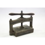 A late Victorian cast iron book press with central worm screw; 19" wide.