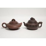 A Chinese Yixing squat round teapot with wave border & dragon handle; & another with relief