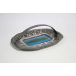 A Liberty & Co. "Tudric" pewter oblong basket dish with over-hang handle, stylised foliate relief