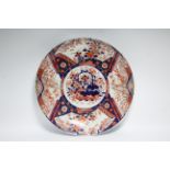 A late 19th century Japanese Imari large shallow dish painted with a basket of flowers to the