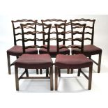 A set of eleven Chippendale style mahogany dining chairs with pierced & waved ladder backs, the