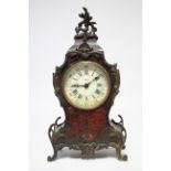 An early 20th century mantel timepiece in the Louis XV style, the boulle inlaid rococo case with