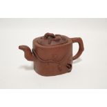 A Chinese Yixing teapot of rounded oblong form with straight sides, moulded decoration of fruiting