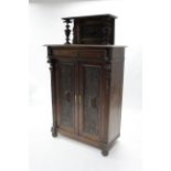 A late 19th century continental walnut side cabinet with raised back, fitted frieze drawer &