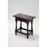 A 17th century-style oak joint stool on turned legs with plain stretchers.