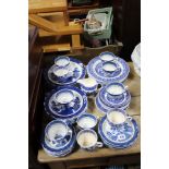 Sixty matched items of blue and white “Willow” pattern dinner and teaware.