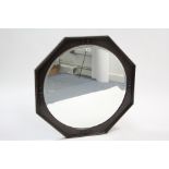 A 1930’s large oak frame octagonal wall mirror with roundels to border & inset bevelled circular