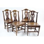 A set of four Georgian-style oak dining chairs with pierced & shaped splat backs, hard seats & on