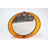 A 1970’s amber tinted Perspex frame oval wall mirror, 17”x 19½”; together with various decorative