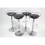 A set of four chrome-finish bar stools with rise and fall action, and with black vinyl seats.